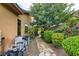 Outdoor utility infrastructure, including a pump and filter, on a stone pathway surrounded by lush greenery at 17 Stonemark Dr, Henderson, NV 89052