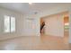 Open living room with tile floors, white walls, and a window allowing for natural light to enter the home at 17 Stonemark Dr, Henderson, NV 89052