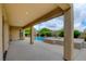 Covered patio overlooking a pool with a spa, and beautiful backyard landscaping at 17 Stonemark Dr, Henderson, NV 89052