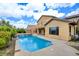 Beautiful backyard with a sparkling pool, lush landscaping, and a covered patio, perfect for relaxation at 17 Stonemark Dr, Henderson, NV 89052