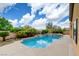 Backyard pool with water feature, surrounded by mature landscaping at 17 Stonemark Dr, Henderson, NV 89052