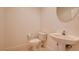 Powder room featuring tile flooring, a pedestal sink, and a toilet with white walls at 17 Stonemark Dr, Henderson, NV 89052