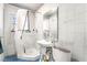 View of bathroom with a white tiled shower, sink, and toilet at 1708 Weeping Willow Ln, Las Vegas, NV 89104