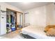 View of a bedroom with a door, mirrored closet doors, and a small window at 1708 Weeping Willow Ln, Las Vegas, NV 89104