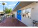 View of a quaint front porch with vibrant blue doors at 1708 Weeping Willow Ln, Las Vegas, NV 89104