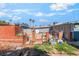 Shows the yard with weathered exteriors, chain-link fencing, and sparse landscaping at 1708 Weeping Willow Ln, Las Vegas, NV 89104