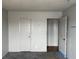 Bedroom with neutral colored walls, carpet, and multiple doors at 204 Bradshaw Way, Las Vegas, NV 89145