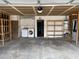 Spacious garage featuring laundry hookups, shelving, and access door to the house at 204 Bradshaw Way, Las Vegas, NV 89145