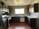 A kitchen with wood cabinets, white countertops, and stainless steel appliances at 204 Bradshaw Way, Las Vegas, NV 89145