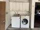 Washer and dryer with cabinets above are conveniently located in the garage at 204 Bradshaw Way, Las Vegas, NV 89145