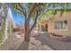 This backyard features desert landscaping, a fire pit, a shade tree and a covered patio at 2152 Mountain City St, Henderson, NV 89052