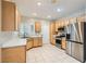 Bright kitchen featuring tile flooring, stainless steel appliances, and ample cabinet space at 2152 Mountain City St, Henderson, NV 89052