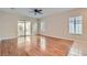 Bright living room featuring wood floors, ceiling fan, slider door, and plantation shutters at 2152 Mountain City St, Henderson, NV 89052