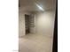 Bedroom featuring ceramic tile flooring, a closet with shelves, and white walls at 220 Mission Newport Ln # 201, Las Vegas, NV 89107