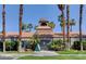 Clubhouse exterior with red tile roof and palm trees at 220 Mission Newport Ln # 201, Las Vegas, NV 89107