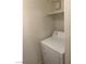 Efficient laundry space with a white washing machine and overhead shelf at 220 Mission Newport Ln # 201, Las Vegas, NV 89107