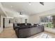 Spacious living room with tiled floors, large windows, and neutral-toned furniture at 220 Mission Newport Ln # 201, Las Vegas, NV 89107