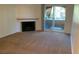 Cozy living room boasting a fireplace and access to a balcony at 220 Mission Newport Ln # 201, Las Vegas, NV 89107