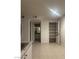 Room with ceramic tile flooring, a full-sized closet, access to the bathroom and views of the kitchen at 220 Mission Newport Ln # 201, Las Vegas, NV 89107