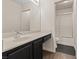 Bathroom featuring black vanity and bath/shower with sliding door at 227 Palmarosa St, Henderson, NV 89015