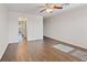 Bedroom with wood-look floors, neutral walls, ceiling fan and arched hallway entrance at 227 Palmarosa St, Henderson, NV 89015