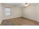 Bright bedroom featuring wood-look floors, neutral walls, a ceiling fan and a window at 227 Palmarosa St, Henderson, NV 89015