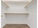 Walk-in closet featuring wood floors and wood shelving at 227 Palmarosa St, Henderson, NV 89015