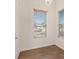 Bright entryway featuring wood-look flooring, a modern light fixture, and sunlit windows with views to the neighborhood at 227 Palmarosa St, Henderson, NV 89015