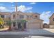 Charming two-story home boasts desert landscaping and an attached two-car garage at 227 Palmarosa St, Henderson, NV 89015