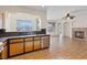 Open kitchen with stainless appliances, tile floors, and an adjacent fireplace at 227 Palmarosa St, Henderson, NV 89015