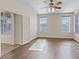 Bright living room featuring hardwood floors, a ceiling fan, and natural light at 227 Palmarosa St, Henderson, NV 89015