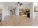 Spacious living room and kitchen area with tile flooring and ceiling fan at 227 Palmarosa St, Henderson, NV 89015