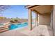 Outdoor covered patio overlooking a pool area with a rock waterfall at 227 Palmarosa St, Henderson, NV 89015