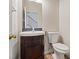 A compact half-bathroom featuring a dark vanity and tile flooring at 227 Palmarosa St, Henderson, NV 89015