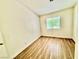 Bedroom with wood-look flooring, natural light from the large window and neutral paint color at 2524 Charleville Ave # 102, Las Vegas, NV 89106