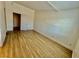 Spacious bedroom featuring sleek floors, white trim, and a door leading to the closet and bathroom at 2524 Charleville Ave # 102, Las Vegas, NV 89106