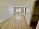 Spacious bedroom with wood-look flooring, closet space, and natural light from the window at 2524 Charleville Ave # 102, Las Vegas, NV 89106