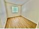 Bedroom features wood-look flooring, natural light from the large window and neutral paint color at 2524 Charleville Ave # 102, Las Vegas, NV 89106