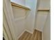 Walk in closet with built-in organizers, shelving, wood-look flooring, and a hanging rod at 2524 Charleville Ave # 102, Las Vegas, NV 89106