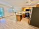 Bright kitchen with stainless steel appliances, stone counters, breakfast bar and wood-look flooring at 2524 Charleville Ave # 102, Las Vegas, NV 89106