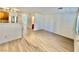 Open-concept space with wood-look flooring, adjacent kitchen, and modern finishes at 2524 Charleville Ave # 102, Las Vegas, NV 89106