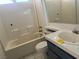 Bright bathroom with tiled walls, a vanity sink, toilet, and a bathtub at 2803 Exulted Valley Ave, North Las Vegas, NV 89032