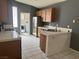Well-lit kitchen with tiled floors, stainless steel appliances, and breakfast bar at 2803 Exulted Valley Ave, North Las Vegas, NV 89032