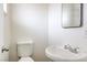 Bathroom featuring a white toilet and sink at 2825 Berg St, North Las Vegas, NV 89030