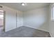 Bedroom with neutral carpet, white walls, a window, and an access door at 2825 Berg St, North Las Vegas, NV 89030