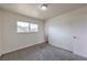 Bedroom featuring a window, neutral carpet, white walls and a door at 2825 Berg St, North Las Vegas, NV 89030