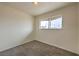 This carpeted bedroom features a window letting in natural light and neutral walls, providing a serene space at 2825 Berg St, North Las Vegas, NV 89030