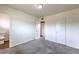 Spacious bedroom with neutral carpet, white walls, and multiple access doors at 2825 Berg St, North Las Vegas, NV 89030