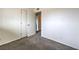 Cozy bedroom featuring neutral carpet, white walls, and two doors for convenient access at 2825 Berg St, North Las Vegas, NV 89030