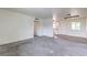 Open-concept living area with new carpet, fresh white walls, and vinyl flooring at 2825 Berg St, North Las Vegas, NV 89030
